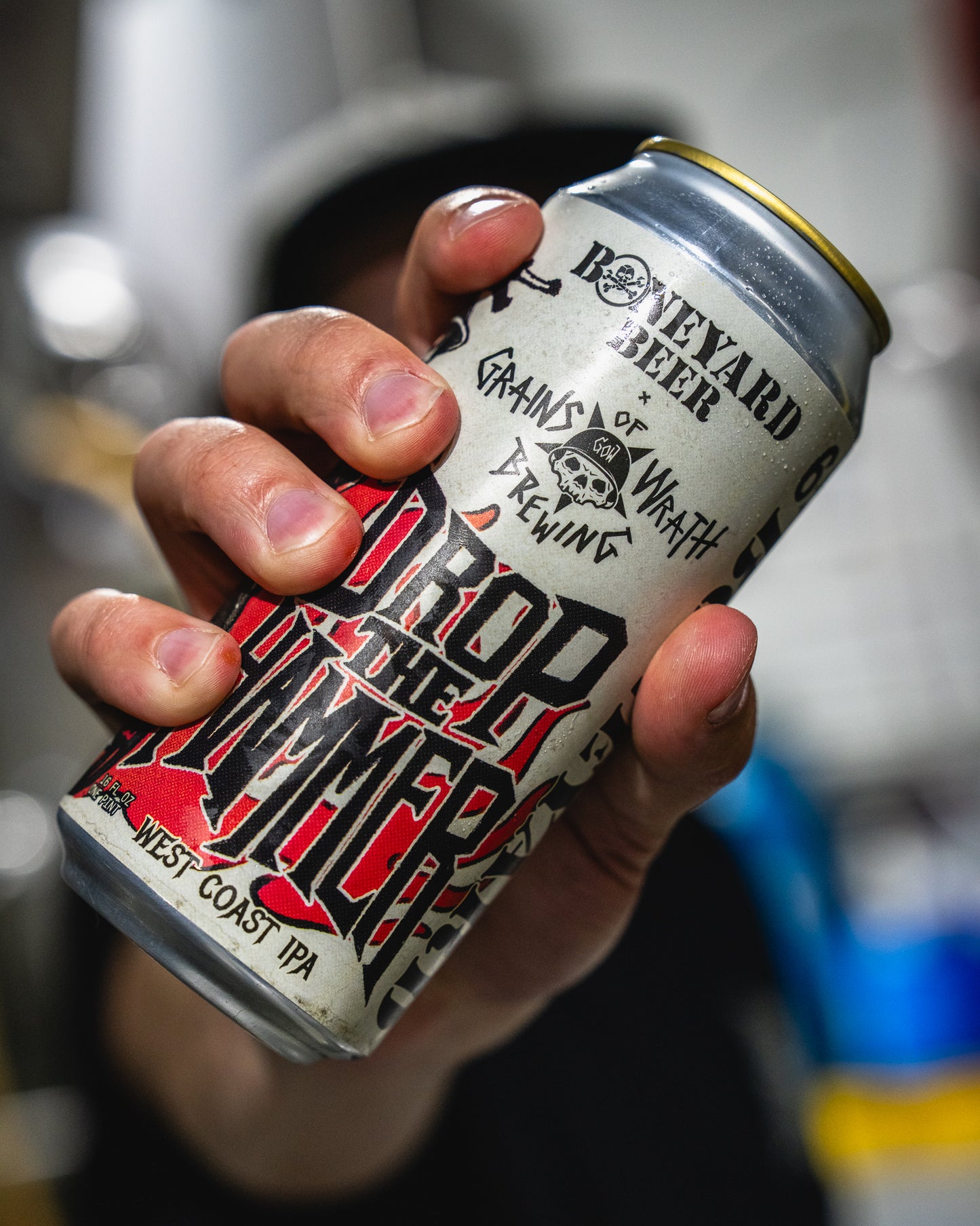 Hand holding a can of Drod the Hammer West Coast IPA