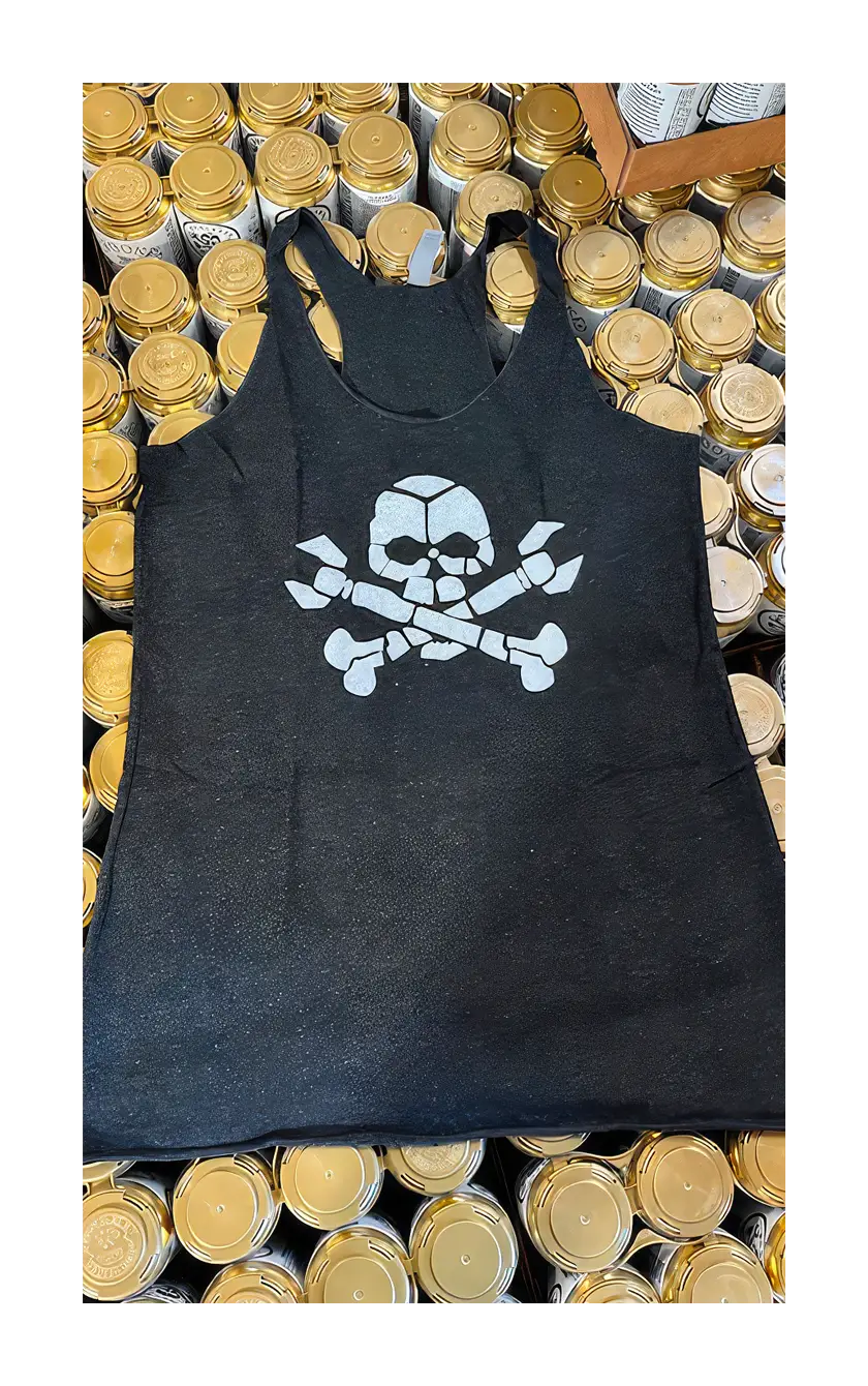 A photograph of the black skull tank on a pallet of beer.