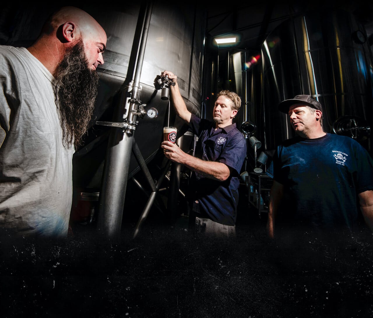 Three members of the team pulling a test beer during production.