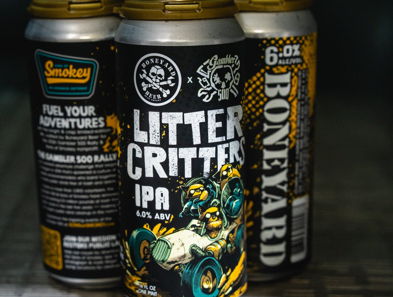 Three beer cans from different brands on a metallic surface with a dark background
