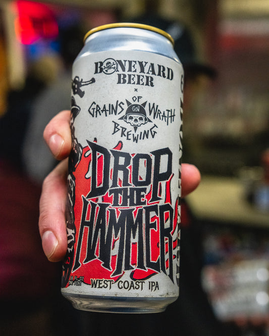 Boneyard Beer x Grains of Wrath collab can held by a hand with a blurred background