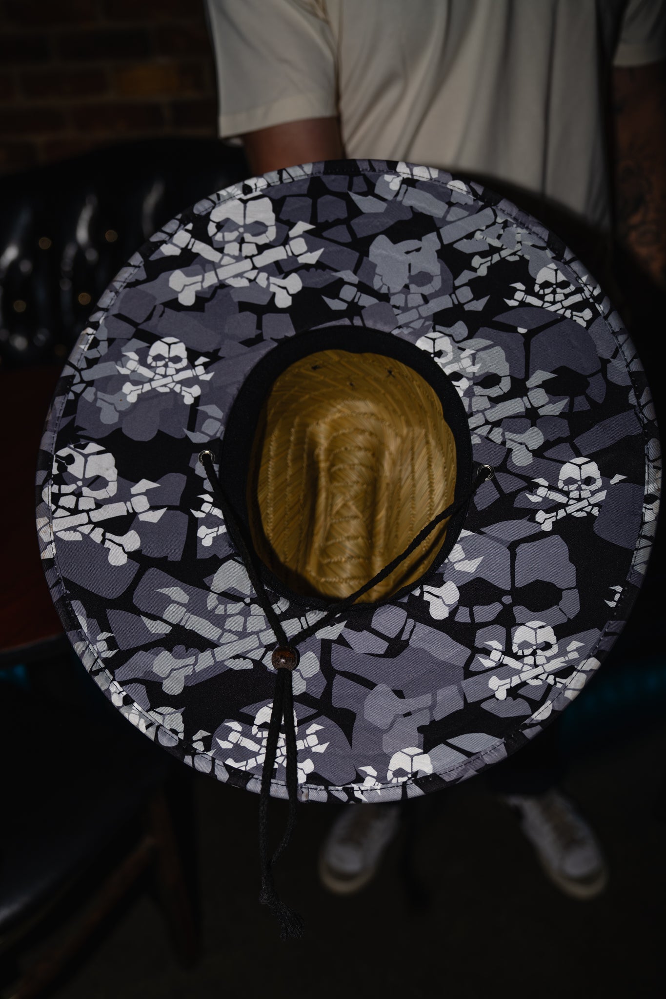 Round object with skull and crossbones pattern on a dark background