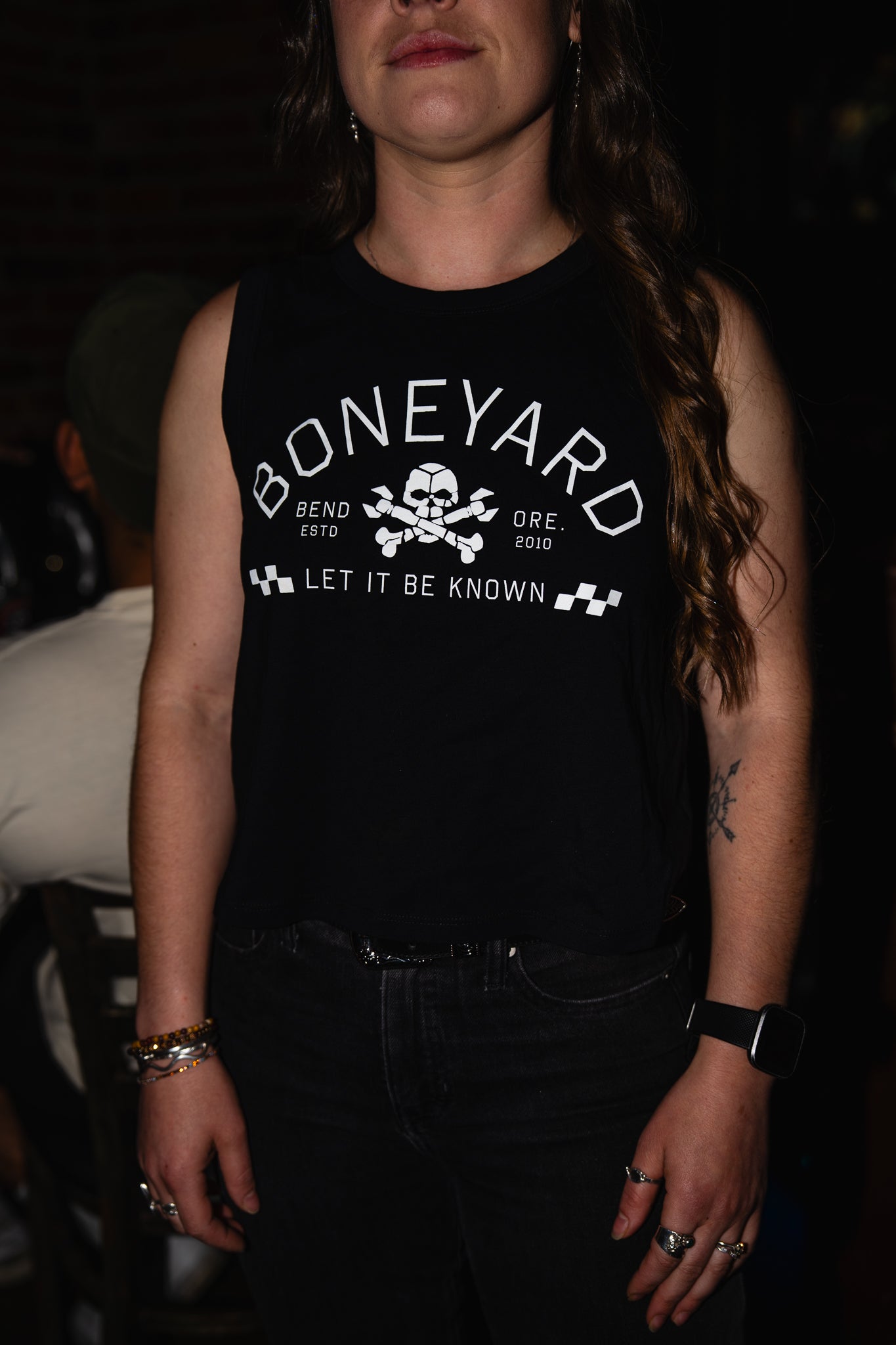 Person wearing a black tank top with 'Boneyard' logo and text.