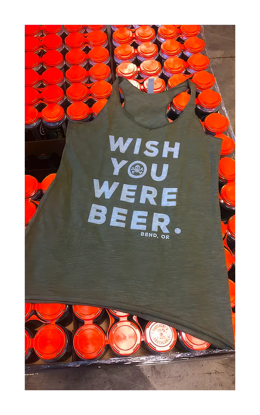 A photograph of the wish you were beer tank on a pallet of beer.