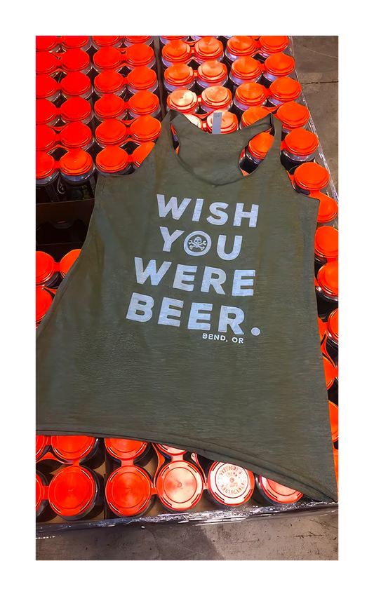 A photograph of the wish you were beer tank on a pallet of beer.